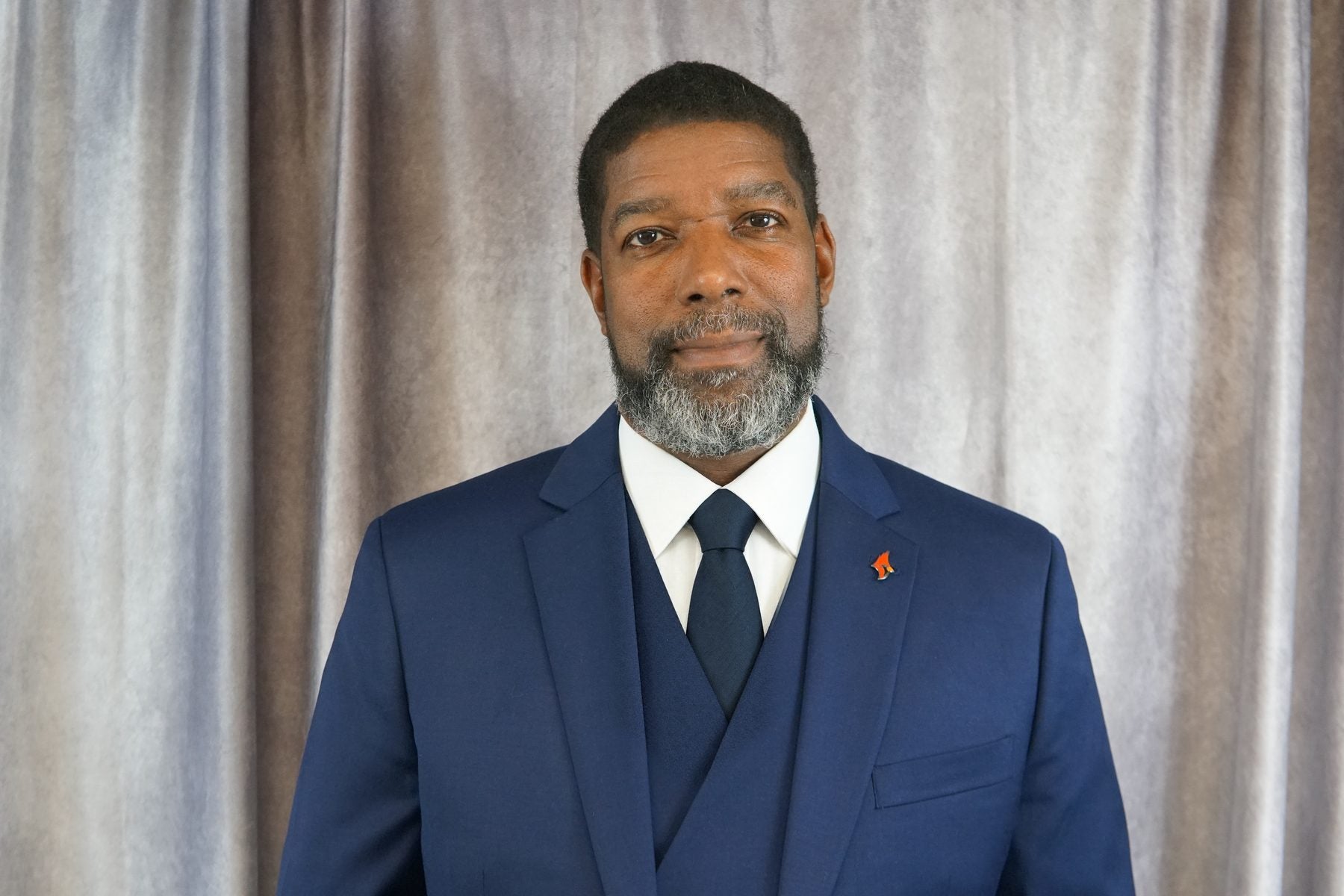 Dr. Henry Pettiegrew II, author of Turnaround Blueprint, in a navy three-piece suit